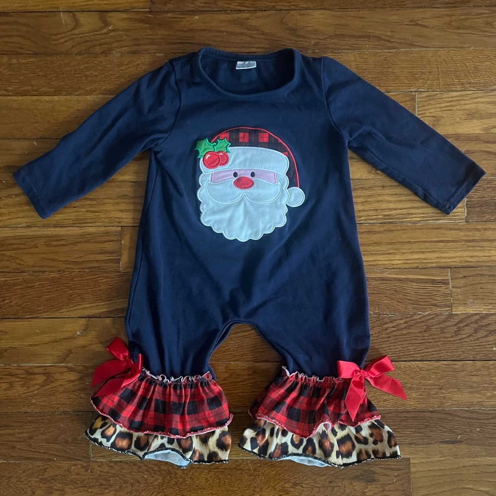 Santa onesie, size 6-12 months. Flare at the foot with ruffle and bow detail.